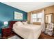Inviting bedroom with a blue accent wall and large windows for natural light at 25261 S Berry Brook Dr, Sun Lakes, AZ 85248