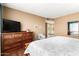 Comfortable bedroom with a dresser, mirror, and a calm, neutral color scheme at 25261 S Berry Brook Dr, Sun Lakes, AZ 85248