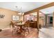 Dining area featuring a dining table, chandelier, and wood laminate flooring at 25261 S Berry Brook Dr, Sun Lakes, AZ 85248