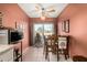 Dining area featuring a ceiling fan, tile flooring, and access to the backyard at 25261 S Berry Brook Dr, Sun Lakes, AZ 85248