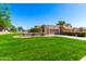 Single Gathering home featuring a well-maintained lawn, desert landscaping, and attached garage at 25261 S Berry Brook Dr, Sun Lakes, AZ 85248