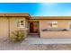 Charming front entrance with custom wooden door, brick accent wall, and desert landscaping at 25261 S Berry Brook Dr, Sun Lakes, AZ 85248