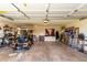 Large garage interior showcasing a golf cart, storage solutions, and ample workspace at 25261 S Berry Brook Dr, Sun Lakes, AZ 85248