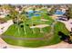 Aerial view of a meticulously maintained golf course with palm trees, sand traps and blue ponds at 25261 S Berry Brook Dr, Sun Lakes, AZ 85248