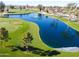 Scenic aerial view of a lush golf course featuring a tranquil pond with a water fountain at 25261 S Berry Brook Dr, Sun Lakes, AZ 85248