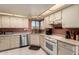 Bright kitchen with white cabinetry, stainless steel dishwasher, and tiled flooring at 25261 S Berry Brook Dr, Sun Lakes, AZ 85248