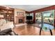Cozy living room featuring a fireplace, built-in shelving, and sliding glass doors to the patio at 25261 S Berry Brook Dr, Sun Lakes, AZ 85248