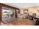 Cozy living room featuring a sliding glass door, ceiling fan, and wood laminate flooring at 25261 S Berry Brook Dr, Sun Lakes, AZ 85248