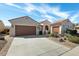 Charming single-story home with a two-car garage, tile roof, and desert landscaping at 26249 W Abraham Ln, Buckeye, AZ 85396