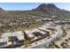 Aerial view of luxury homes in a desert community, showcasing modern architecture and mountain views at 27000 N Alma School Pkwy # 1024, Scottsdale, AZ 85262