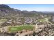 An aerial view of a golf course community surrounded by desert landscaping and mountain views at 27000 N Alma School Pkwy # 1024, Scottsdale, AZ 85262