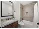 This bathroom features a granite-topped vanity, modern fixtures, and tiled shower and tub combo at 27000 N Alma School Pkwy # 1024, Scottsdale, AZ 85262