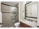 Modern bathroom featuring a glass door shower, tiled walls, and a vanity with granite counter at 27000 N Alma School Pkwy # 1024, Scottsdale, AZ 85262