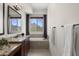 Bright bathroom featuring double vanity sinks, granite countertops, a soaking tub and picturesque window views at 27000 N Alma School Pkwy # 1024, Scottsdale, AZ 85262