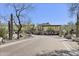 An entrance gate with desert landscaping, stone pillars, and a brick-paved driveway at 27000 N Alma School Pkwy # 1024, Scottsdale, AZ 85262