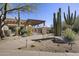 Beautifully landscaped walkway leading to a gated entrance, surrounded by desert plants and trees at 27000 N Alma School Pkwy # 1024, Scottsdale, AZ 85262
