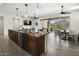 Open kitchen with a large island, modern appliances, and seamless flow to the dining and living areas at 27000 N Alma School Pkwy # 1024, Scottsdale, AZ 85262