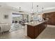 Bright, open-concept kitchen with granite countertops, wood cabinets, and seamless access to outdoor living space at 27000 N Alma School Pkwy # 1024, Scottsdale, AZ 85262