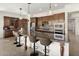 Bright kitchen with stainless steel appliances, a spacious island, and modern light fixtures for a luxurious feel at 27000 N Alma School Pkwy # 1024, Scottsdale, AZ 85262