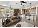 Open-concept living space with kitchen island, comfortable seating, and modern lighting design creating a welcoming atmosphere at 27000 N Alma School Pkwy # 1024, Scottsdale, AZ 85262