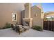 Cozy outdoor patio with a fireplace, seating, and privacy landscaping for relaxing evenings at 27000 N Alma School Pkwy # 1024, Scottsdale, AZ 85262