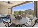 Covered patio with a dining table offering stunning views of the surrounding desert landscape at 27000 N Alma School Pkwy # 1024, Scottsdale, AZ 85262