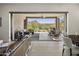 Inviting outdoor patio with comfortable seating, dining area, and desert views seamlessly connected to the living space at 27000 N Alma School Pkwy # 1024, Scottsdale, AZ 85262