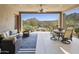 Covered patio with comfortable seating and a dining table offering stunning desert views at 27000 N Alma School Pkwy # 1024, Scottsdale, AZ 85262