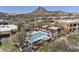 A community pool with a spa, pergola, lounge chairs, and desert landscaping nestled amongst luxury homes at 27000 N Alma School Pkwy # 1024, Scottsdale, AZ 85262