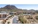 A street view of luxury homes in a desert community, showcasing modern architecture and mountain views at 27000 N Alma School Pkwy # 1024, Scottsdale, AZ 85262