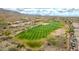 Scenic aerial view showcasing the golf course in relation to the homes in the community at 3138 W Ravina Ln, Anthem, AZ 85086