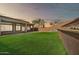 Expansive backyard featuring artificial turf and a retaining wall with a water feature at 3138 W Ravina Ln, Anthem, AZ 85086