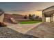 A spacious backyard featuring a large flagstone patio, steps, and a well-manicured lawn at 3138 W Ravina Ln, Anthem, AZ 85086