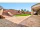 Multi-tiered backyard featuring artificial turf, stone pavers, steps, and wall at 3138 W Ravina Ln, Anthem, AZ 85086