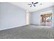 Carpeted bedroom with a ceiling fan and sliding door access to the backyard at 3138 W Ravina Ln, Anthem, AZ 85086