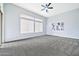 Spacious bedroom with plush carpeting, large windows, and a serene atmosphere at 3138 W Ravina Ln, Anthem, AZ 85086