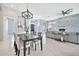 Open-concept dining room and living room featuring modern light fixtures at 3138 W Ravina Ln, Anthem, AZ 85086