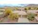 Aerial view of the home showcasing a three-car garage and desert landscaping at 3138 W Ravina Ln, Anthem, AZ 85086