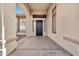 The front porch is shaded by the roof with the front door facing the street at 3138 W Ravina Ln, Anthem, AZ 85086
