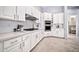 Elegant kitchen featuring white cabinets, stone countertops, stainless steel appliances, and modern fixtures at 3138 W Ravina Ln, Anthem, AZ 85086