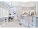 Bright kitchen and breakfast nook featuring white cabinetry, a breakfast bar, and modern decor at 3138 W Ravina Ln, Anthem, AZ 85086