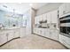 Bright kitchen featuring white cabinets, stone countertops, stainless steel appliances, and modern fixtures at 3138 W Ravina Ln, Anthem, AZ 85086