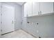 Spacious laundry room with white cabinets, tiled flooring, and utility connections at 3138 W Ravina Ln, Anthem, AZ 85086