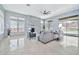 Spacious living room with a stacked stone fireplace, comfortable seating, and view of the backyard at 3138 W Ravina Ln, Anthem, AZ 85086