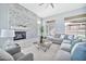 Bright living room featuring a stone fireplace, a ceiling fan, and neutral-colored decor at 3138 W Ravina Ln, Anthem, AZ 85086