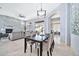 Open-concept living space with stone fireplace, elegant dining table, neutral tones, and outdoor views at 3138 W Ravina Ln, Anthem, AZ 85086