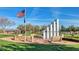 Outdoor memorial with American flag, stepped monument, and benches in a well-kept park at 3138 W Ravina Ln, Anthem, AZ 85086
