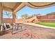 Covered patio with comfortable seating area overlooking landscaped backyard at 3138 W Ravina Ln, Anthem, AZ 85086