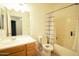 Bright bathroom featuring a shower over tub with a shower curtain and a vanity with a mirror at 3150 E Beardsley Rd # 1105, Phoenix, AZ 85050