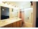 Bright bathroom featuring double sinks, a large mirror, and a shower-tub combination, perfect for daily routines at 3150 E Beardsley Rd # 1105, Phoenix, AZ 85050